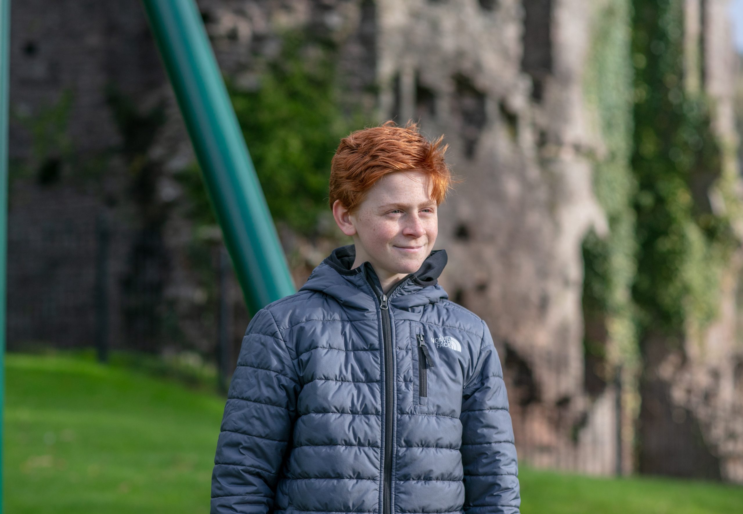 A boy looking in a distance with a smile