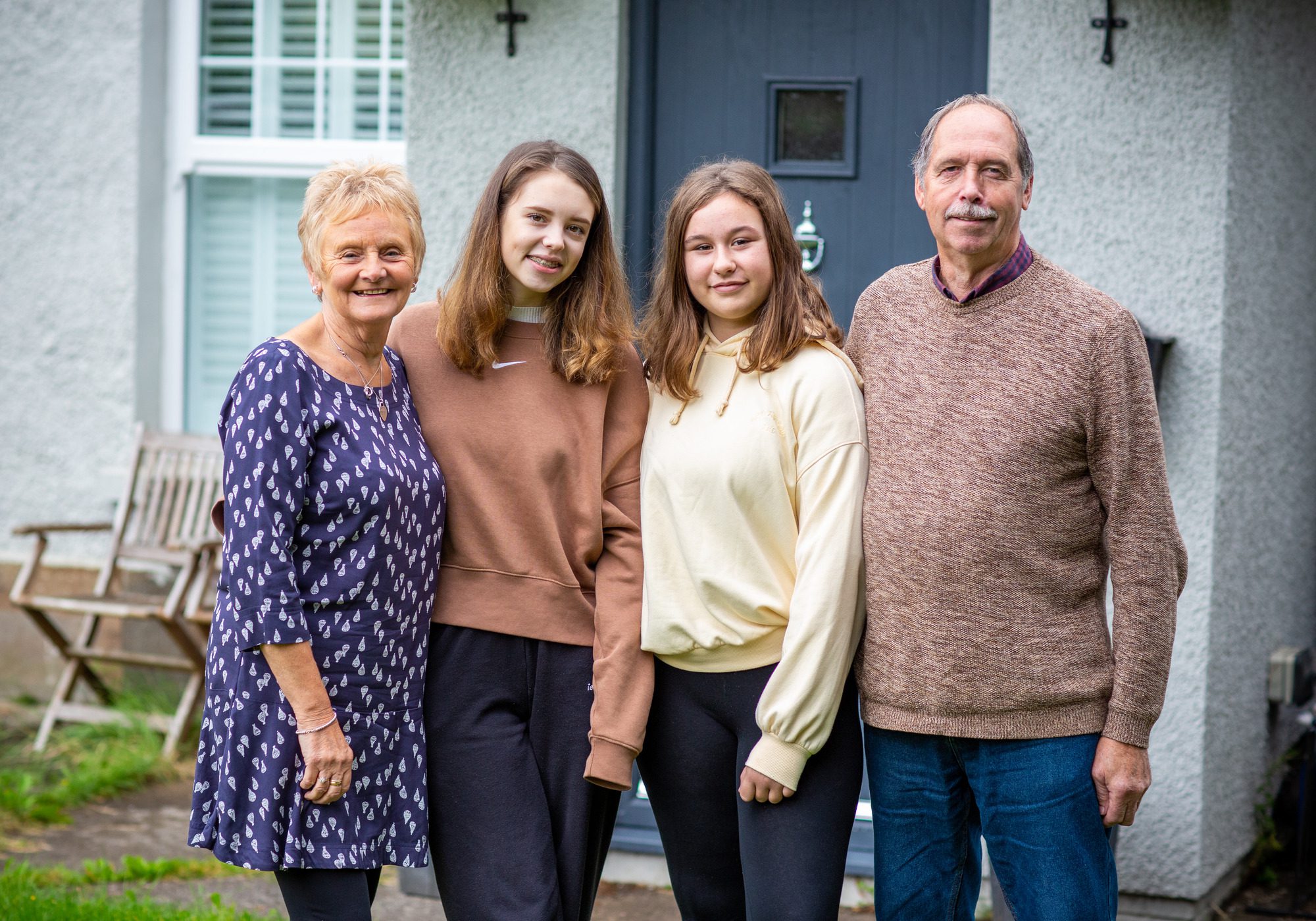 A family standing outside their house