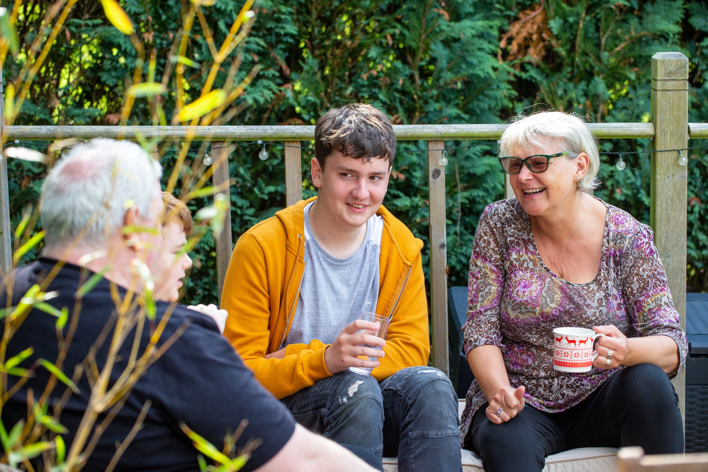Ellen and Paul, two foster carers sat in the garden